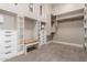 Custom walk-in closet featuring built-in shelving, drawers, and ample storage space at 7456 S Brighton --, Queen Creek, AZ 85142