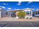 Single-wide manufactured home with carport and landscaped yard at 7750 E Broadway Rd # 684, Mesa, AZ 85208