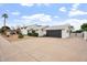 Single-Gathering home boasts a large driveway, well-kept lawn, and an attached two-car garage at 8531 E Laredo Ln, Scottsdale, AZ 85250