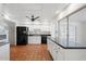 Bright kitchen with white cabinets, black appliances, tile floors, and ample countertop space at 8531 E Laredo Ln, Scottsdale, AZ 85250