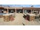 A spacious brick patio connects the outdoor kitchen and covered seating areas with an elevated staircase at 9015 E Hackamore Dr, Scottsdale, AZ 85255