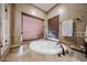 Bright bathroom featuring a large soaking tub under a pair of windows at 9015 E Hackamore Dr, Scottsdale, AZ 85255