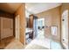 Bathroom with vanity and storage; neutral tile flooring, and view to living area and walk-in shower at 9015 E Hackamore Dr, Scottsdale, AZ 85255