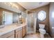 Bathroom featuring a glass enclosed shower, toilet, and vanity with marble countertop at 9015 E Hackamore Dr, Scottsdale, AZ 85255