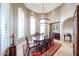 Elegant dining room with a grand chandelier, arched windows, and a large table, perfect for formal gatherings at 9015 E Hackamore Dr, Scottsdale, AZ 85255