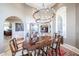 Well-lit dining room with a large wooden table, comfortable seating, and a decorative rug, designed for memorable meals at 9015 E Hackamore Dr, Scottsdale, AZ 85255