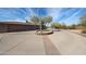 Driveway with a three-car garage and beautiful desert landscaping at 9015 E Hackamore Dr, Scottsdale, AZ 85255