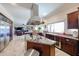 Spacious kitchen featuring granite countertops, stainless steel appliances, and an island with a cooktop at 9015 E Hackamore Dr, Scottsdale, AZ 85255