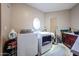 Laundry room featuring a washer, a dryer, a window and overhead cabinets at 9015 E Hackamore Dr, Scottsdale, AZ 85255