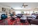 Spacious living room with a stacked stone fireplace, plush seating, and a decorative oriental rug at 9015 E Hackamore Dr, Scottsdale, AZ 85255