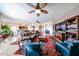 Expansive living area featuring a ceiling fan, comfortable leather sofas, and an eye-catching oriental rug at 9015 E Hackamore Dr, Scottsdale, AZ 85255