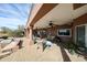 Covered patio featuring an outdoor kitchen, bar area and a comfortable seating area at 9015 E Hackamore Dr, Scottsdale, AZ 85255