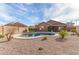 Inviting kidney-shaped pool with gravel decking and desert landscaping at 9016 W Harmony Ln, Peoria, AZ 85382