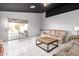 Living room with tiled floors, neutral-toned furniture, and access to the backyard at 9016 W Harmony Ln, Peoria, AZ 85382