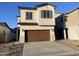 Two-story house with brown garage door and Spanish-style detailing at 9346 E Sequence Ave, Mesa, AZ 85212