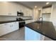 Modern kitchen with white cabinets, black countertops and island at 9346 E Sequence Ave, Mesa, AZ 85212