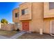 Tan two-story townhome with red door and small front yard at 948 S Alma School Rd # 29, Mesa, AZ 85210