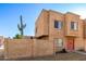 Tan two-story townhome with red door and small front yard at 948 S Alma School Rd # 29, Mesa, AZ 85210