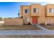 Tan two-story townhome with red door and small front yard at 948 S Alma School Rd # 29, Mesa, AZ 85210