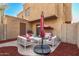 Private patio with seating area, red mulch, and a covered swing at 948 S Alma School Rd # 29, Mesa, AZ 85210