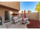 Private patio with seating area, red mulch, and a covered swing at 948 S Alma School Rd # 29, Mesa, AZ 85210