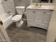 Clean bathroom featuring a white vanity and gray floor tile at 9902 W Coggins Dr, Sun City, AZ 85351