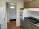 Kitchen with oven, stovetop, and view into hallway at 9902 W Coggins Dr, Sun City, AZ 85351