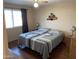 Main bedroom with queen bed and wood-look floors at 9902 W Coggins Dr, Sun City, AZ 85351