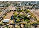 Aerial view of estate with defined property lines, mature landscaping, and equestrian facilities at 9980 E Charter Oak Rd, Scottsdale, AZ 85260