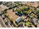 Aerial view of estate showcasing horse facilities, a pool, mature trees, and a putting green at 9980 E Charter Oak Rd, Scottsdale, AZ 85260