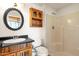 Cozy bathroom with a decorative mirror and tiled shower at 9980 E Charter Oak Rd, Scottsdale, AZ 85260