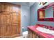 Unique bathroom features decorative tile counter, framed mirror, and a spacious built-in cabinet at 9980 E Charter Oak Rd, Scottsdale, AZ 85260