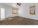 Bedroom featuring plush carpet, neutral walls and a fan at 9980 E Charter Oak Rd, Scottsdale, AZ 85260