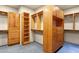 Walk-in closet featuring wood cabinets, drawers and shelving at 9980 E Charter Oak Rd, Scottsdale, AZ 85260