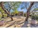 Large brick courtyard with well placed trees offering shade to the property and a fire pit at 9980 E Charter Oak Rd, Scottsdale, AZ 85260