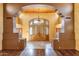 Grand foyer with a stunning chandelier, wood ceiling, and elegant double doors, creating a luxurious entrance at 9980 E Charter Oak Rd, Scottsdale, AZ 85260