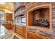 Kitchen with custom cabinets, stone accents, and a chef's fireplace at 9980 E Charter Oak Rd, Scottsdale, AZ 85260