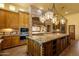 Well-equipped kitchen with a stone backsplash and a central island at 9980 E Charter Oak Rd, Scottsdale, AZ 85260