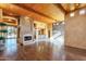 Open-concept living room with hardwood floors, a stone fireplace, and ample natural light, perfect for entertaining at 9980 E Charter Oak Rd, Scottsdale, AZ 85260