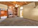 Spacious living room with beautiful wood beam ceiling and fireplace at 9980 E Charter Oak Rd, Scottsdale, AZ 85260