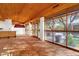 Spacious living room with a wood ceiling, tile floors, and expansive windows offering great outdoor views at 9980 E Charter Oak Rd, Scottsdale, AZ 85260