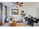 A cozy living room features a neutral sofa, round coffee table, and a modern ceiling fan at 1232 E Kaler Dr, Phoenix, AZ 85020