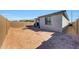 Spacious backyard with a firepit and view of the home's exterior at 12530 W Levi Dr, Avondale, AZ 85323