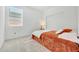 Cozy bedroom with orange bedding and window blinds at 12530 W Levi Dr, Avondale, AZ 85323