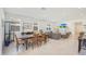 Open concept dining area with modern table and adjacent living room at 12530 W Levi Dr, Avondale, AZ 85323
