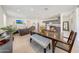 Open concept dining room with large table and living room view at 12530 W Levi Dr, Avondale, AZ 85323