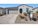 Modern single story home with gray garage and desert landscaping at 12530 W Levi Dr, Avondale, AZ 85323