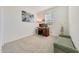 Home office features wood desk, window with blinds, and plush bench at 12530 W Levi Dr, Avondale, AZ 85323