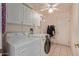 Bright laundry room, washer, dryer, cabinets, and built in sink at 13652 W Aleppo Dr, Sun City West, AZ 85375