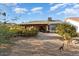 Backyard view of home with gravel and trees at 13907 W Gable Hill Dr, Sun City West, AZ 85375